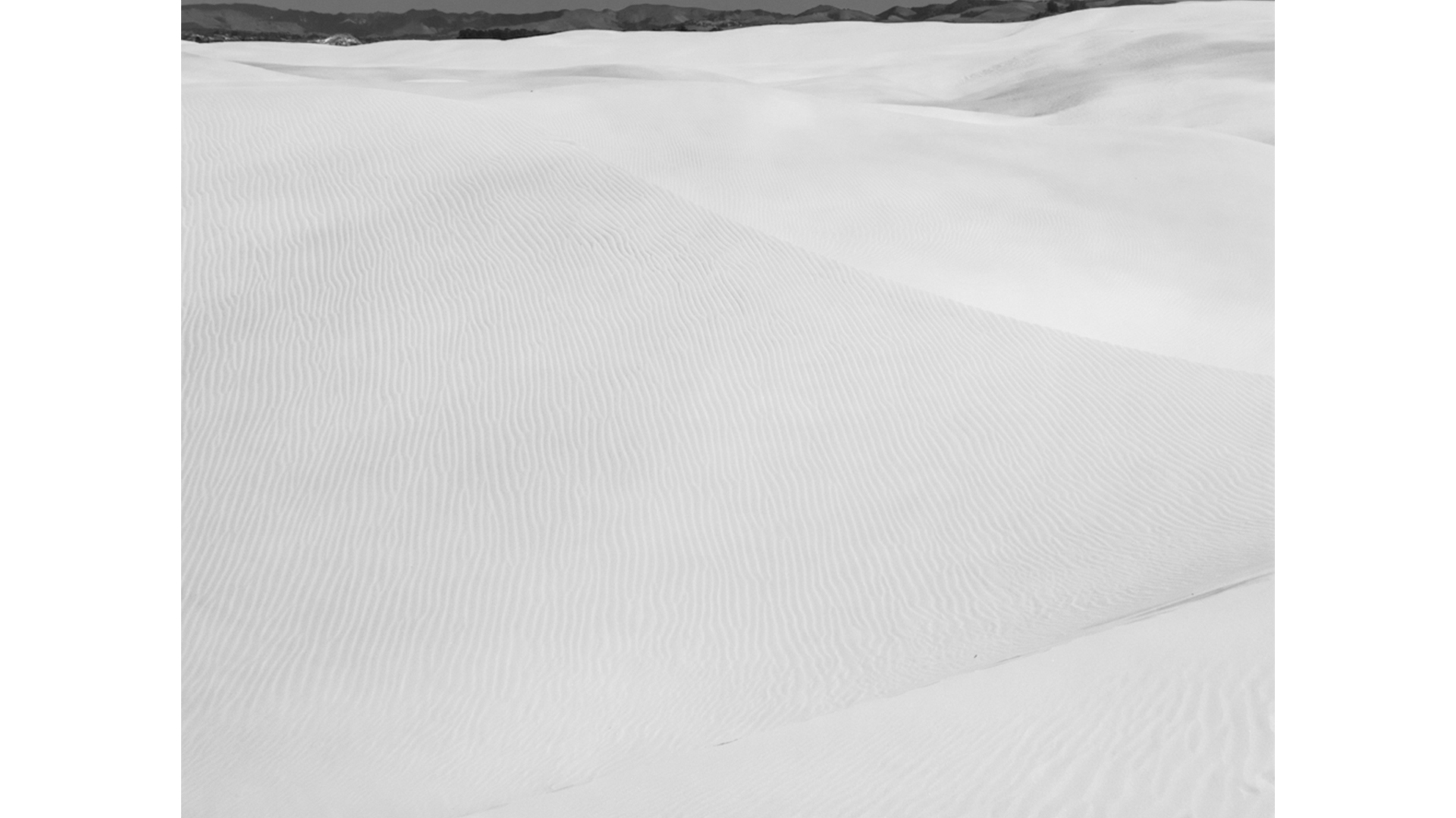 black and white, sand at pismo dunes, mountians in the distance