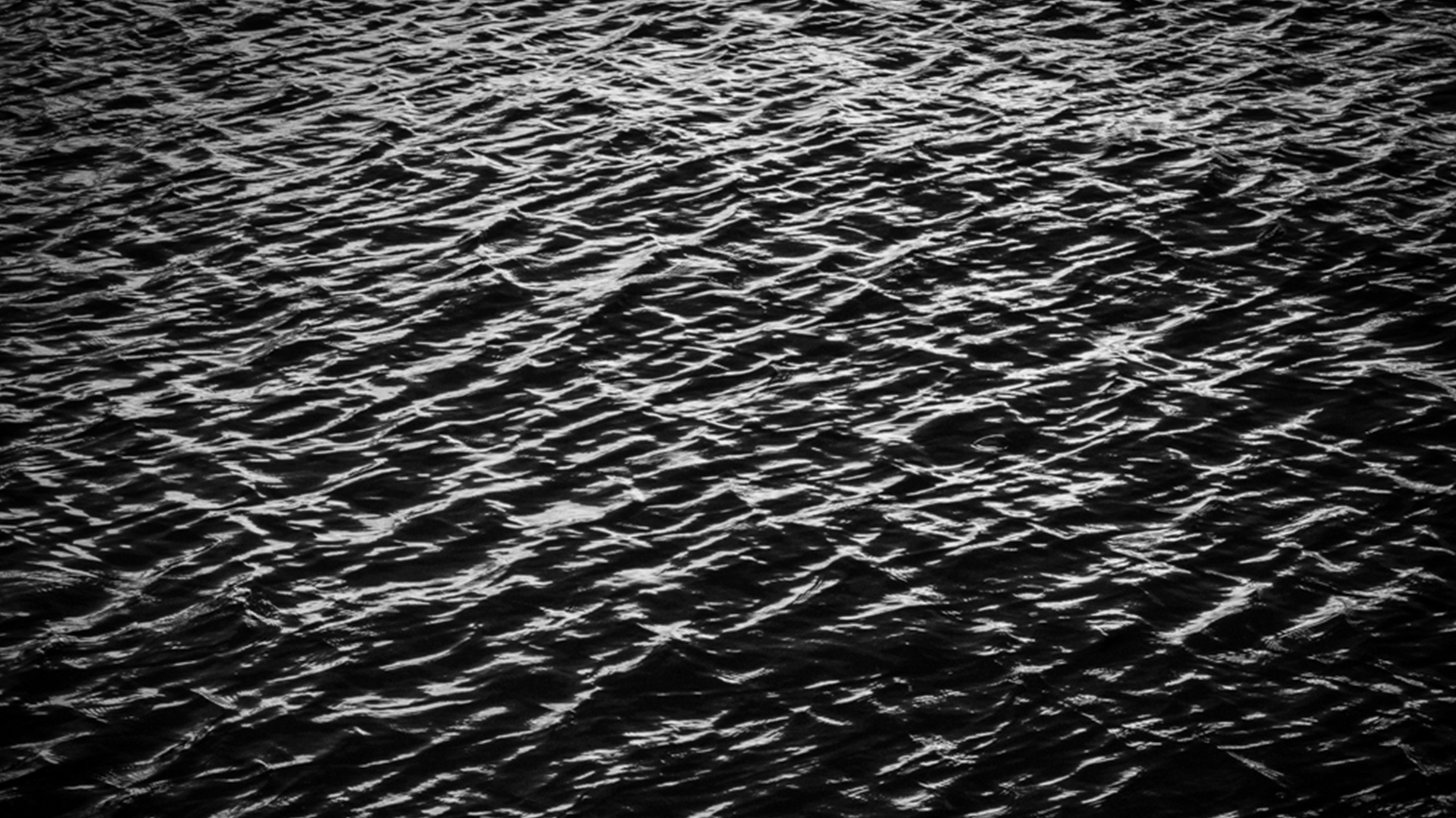 the texture of ripling water, black and white
